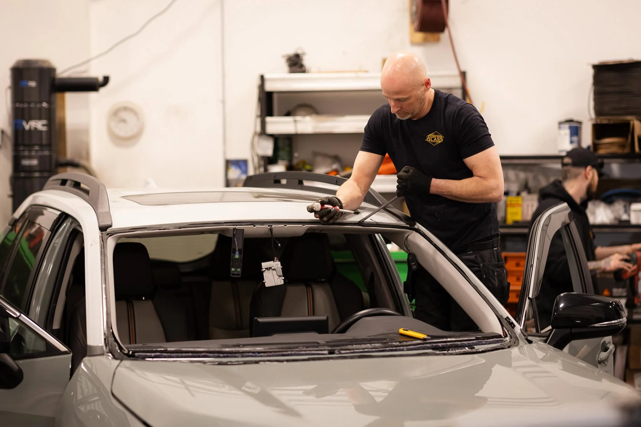 Windshield being repaired on grey vehicle